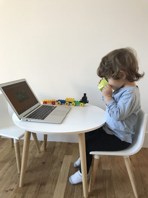 The next generation at work — a child quietly using a laptop at a small table